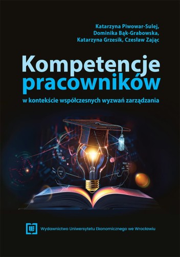 Czarna okładka przedstawiająca rozłożoną książkę nad nią świeci żarówka którą przykrywa biret.